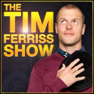The cover art for Tim Ferriss's Show. The art has a black and gold border. In the top left corner is the show's title in large, sans-serif all-caps golden font. A solar flare shines in the middle of the title. In front of the title, overlapping only a small portion of the letters, is a photograph of Tim Ferriss in the bottom right hand corner. He holds a hat to his chest and looks up and to the right.